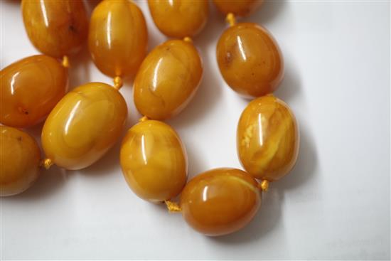 A single strand amber bead necklace, 76cm.